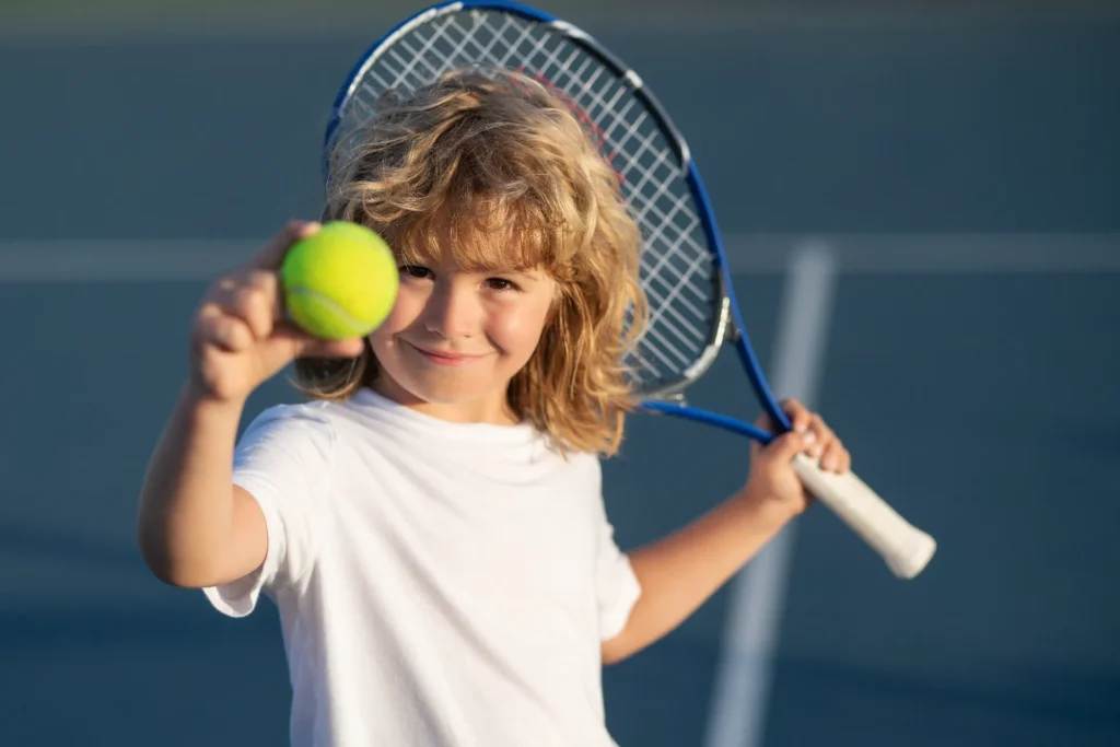 child playing tennis outdoor court child with tennis ball sport child with racket tennis playg